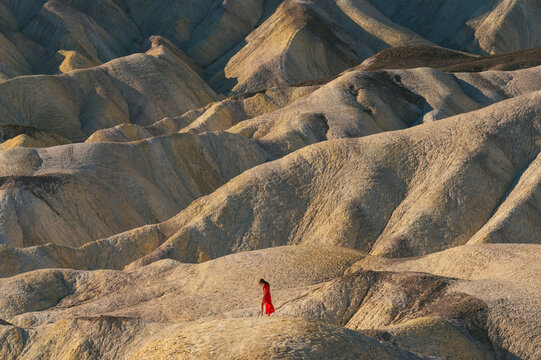 Female in a red dress at Zabriskie Point in Death Valley National Park
