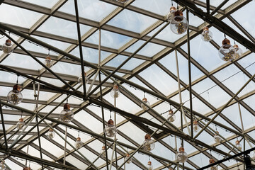 Fototapeta premium Glass roof and pendant lamps in form of large light bulbs.