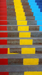 colourful stripes painted on metal stairs in red yellow and blue colours