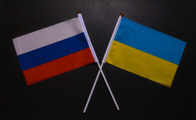 Small flags of the USA and Ukraine on a black background.Ukraine russia conflict.
