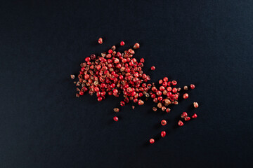 Heap of red peppercorns on black