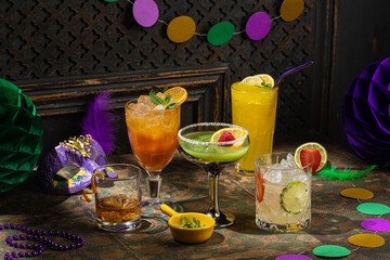 Alcoholic cocktails, Mardi Gras decoration on dark background