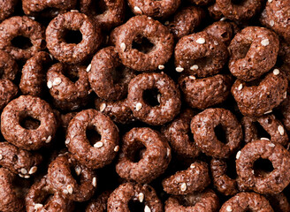 Dry breakfast rings chocolate background. Top view