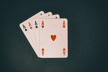 Obraz premium Four aces on green background in vintage style