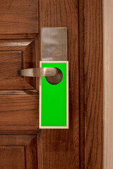 A blank door hanger on a door, with copy space, add text or graphic