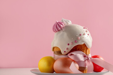 Easter cakes, traditional multi-colored eggs on the festive table, on a pink background