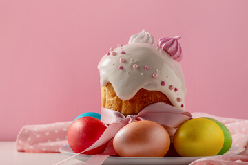 Easter cakes, traditional multi-colored eggs on the festive table, on a pink background
