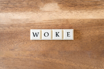 Fototapeta premium The word Woke on a wooden background.