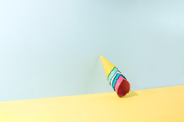 Colored ice cream cones leaning against the wall. Bright summer minimum concept idea