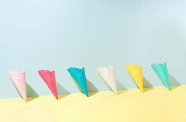 Colored ice cream cones leaning against the wall. Bright summer minimum concept idea