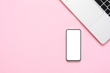 Top view of blank screen smartphone and laptop keyboard on pink paper background. Flat lay, copy space, mock up.