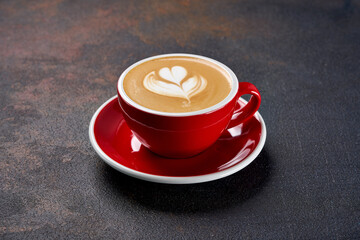 Red cup with coffee on a black background