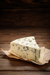 Tasty blue cheese on wooden table.