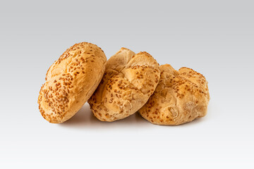 Few kaiser rolls sprinkled with sesame seeds