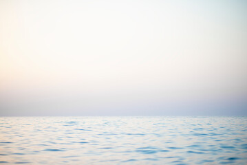 Abstract calm sunset sky and ocean nature background with blurred panning motion.