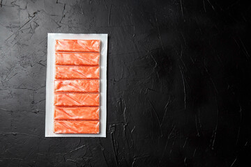 Crab sticks or imitation crab meat on black table © mikeosphoto