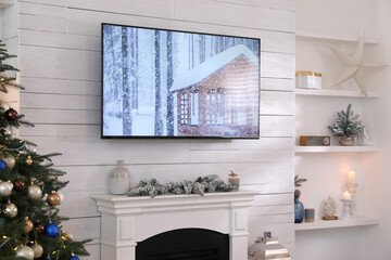 Stylish living room interior with modern TV and Christmas tree