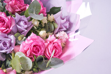 Part of a colorful bouquet of flowers. Big pink roses. On a light background, top view, copy space. High quality photo