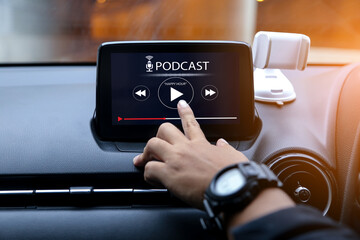 Podcast concept.Hands put at play button on multimedia system in the car