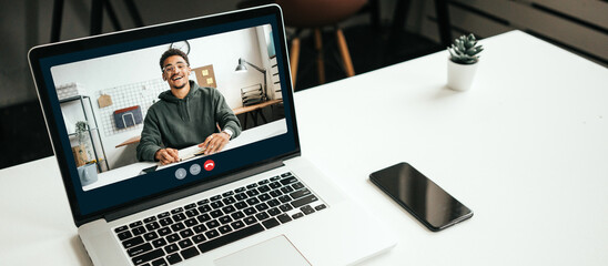 Laptop on the table with video conference call, african-american man talking