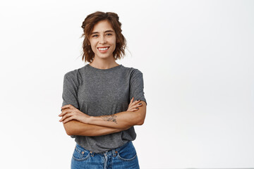 Happy smiling young hispanic woman, wearing grey t-shirt, looking cheerful, standing confident...