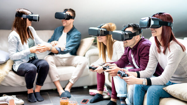 Students having fun with vr headset at home - Virtual reality and metaverse gaming concept with people having fun on 3d videogames - Shape of technologic gears has been modified - Bright filter