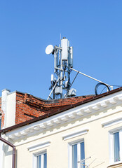 Telecommunication tower for mobile phone with antennas on a roof