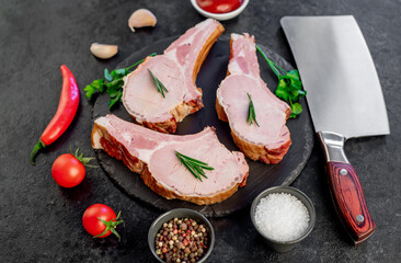 smoked pork steaks on the bone on a stone background