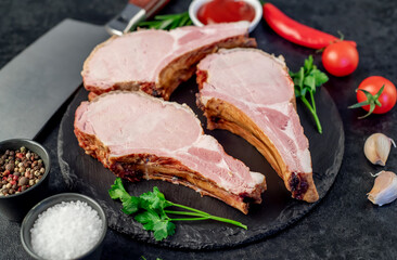 smoked pork steaks on the bone on a stone background