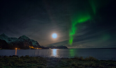 Aurora Borealis on sky in Flakstad island, Lofoten archipelago