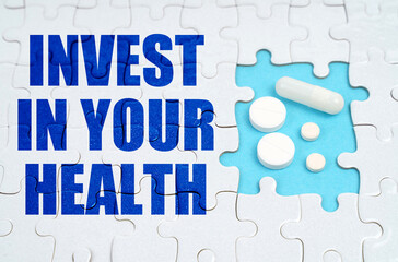 On the puzzles there is an inscription - INVEST IN YOUR HEALTH, on a blue background pills.