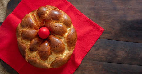 Easter Greek tsoureki braid overhead. Sweet bread brioche on wooden table