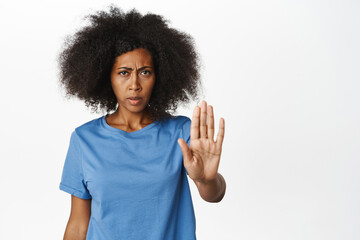 Stop. Serious african woman extends hand, taboo stop gesture, prohibit smth, warning sign, forbid...