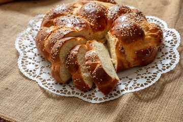 Easter sweet bread, greek tsoureki, brioche braid slice on table, close up view