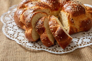 Easter sweet bread, greek tsoureki, brioche braid slice on table, close up view