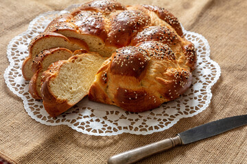 Easter sweet bread, greek tsoureki, brioche braid slice on table, close up view