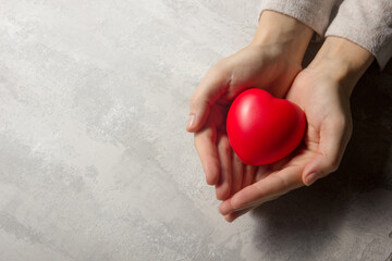 Woman hands holding red heart, health care, love, organ donation, family insurance and CSR concept....