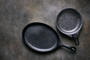 Two empty skillets close up, top view, space for text