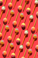 Colorful Set of Lollipops. pattern made with caramel on a stick on bright pink background.  creative pattern.  lot of lollipops chupa chups...