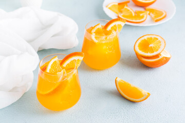 Hard seltzer cocktail with orange in glasses on the table. Homemade drink.