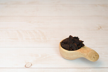 Jerky meat on a wooden background. Dried beef.