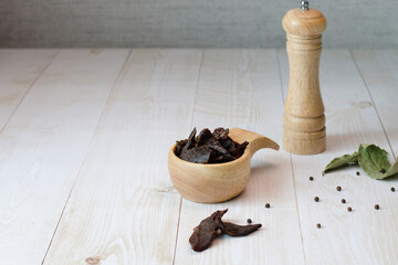Jerky meat on a wooden background. Dried beef.