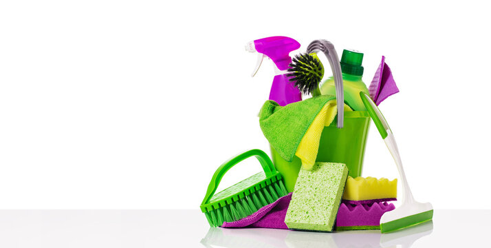 Household Cleaning Tools And Sundry Items Spring Cleaning Kitchen, Bathroom And Other Rooms. Isolated On White Table. Cleaning Service Concept. Green And Vibrant Violet