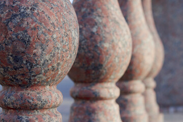 close up of red granite balusters in the city