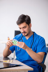 Young male doctor working in the clinic