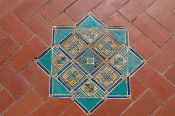 Turquoise, Blue, Gold and Yellow Square and Diamond Tile Design Inset on Running Bond Red Brick 