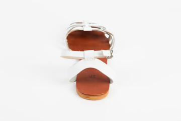 White leather women's sandals with low heels.