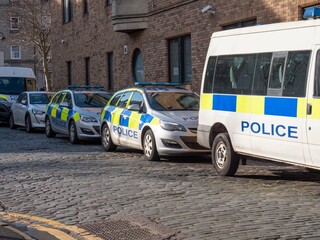 A line of parked police emergency vehicles UK
