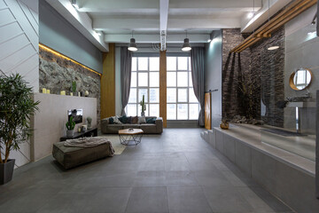 Fototapeta na wymiar brutal ultra trendy interior design of an open-plan apartment with an open shower decorated with gray stone