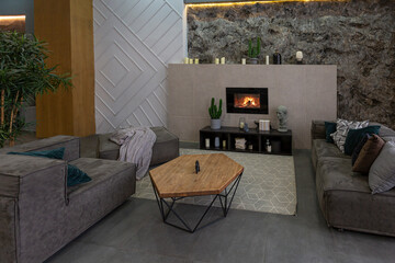 modern studio interior with decorative stone walls in grey. stone wood, tiles and led lighting in the design of the room